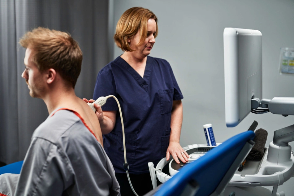 Man receiving ultrasound scan of shoulder